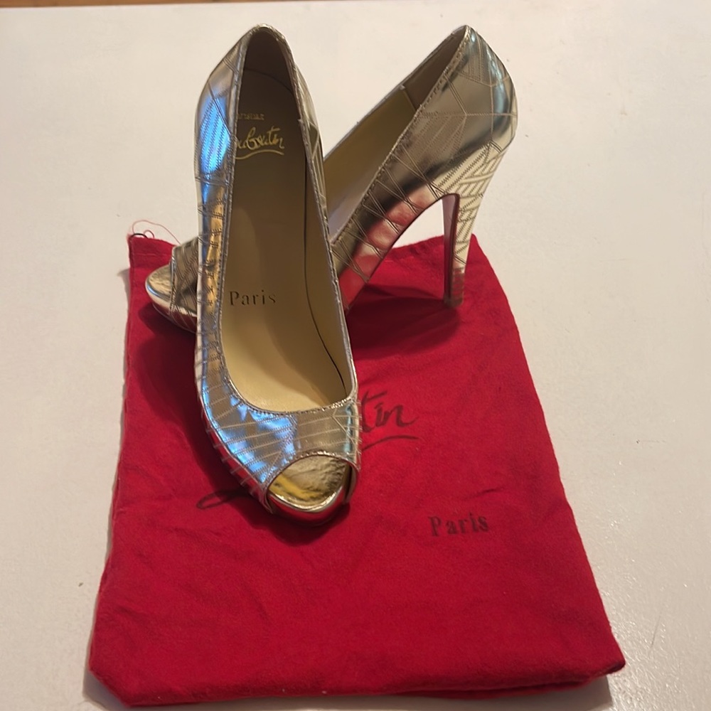 Brand new gold tone, red sole designer shoes.